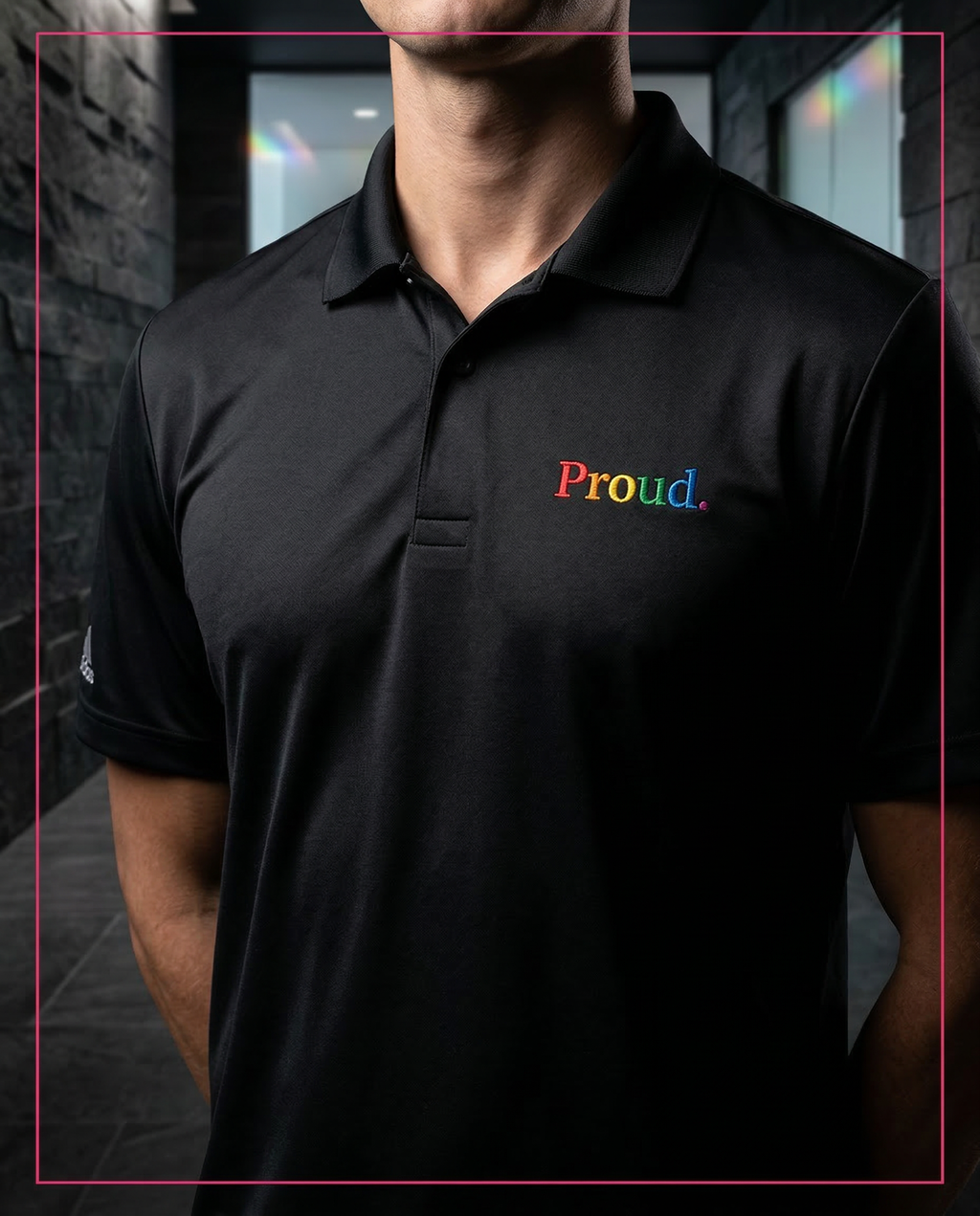 Person wearing a black polo shirt with 'Proud.' in colorful letters. Proud Adidas Performance Polo