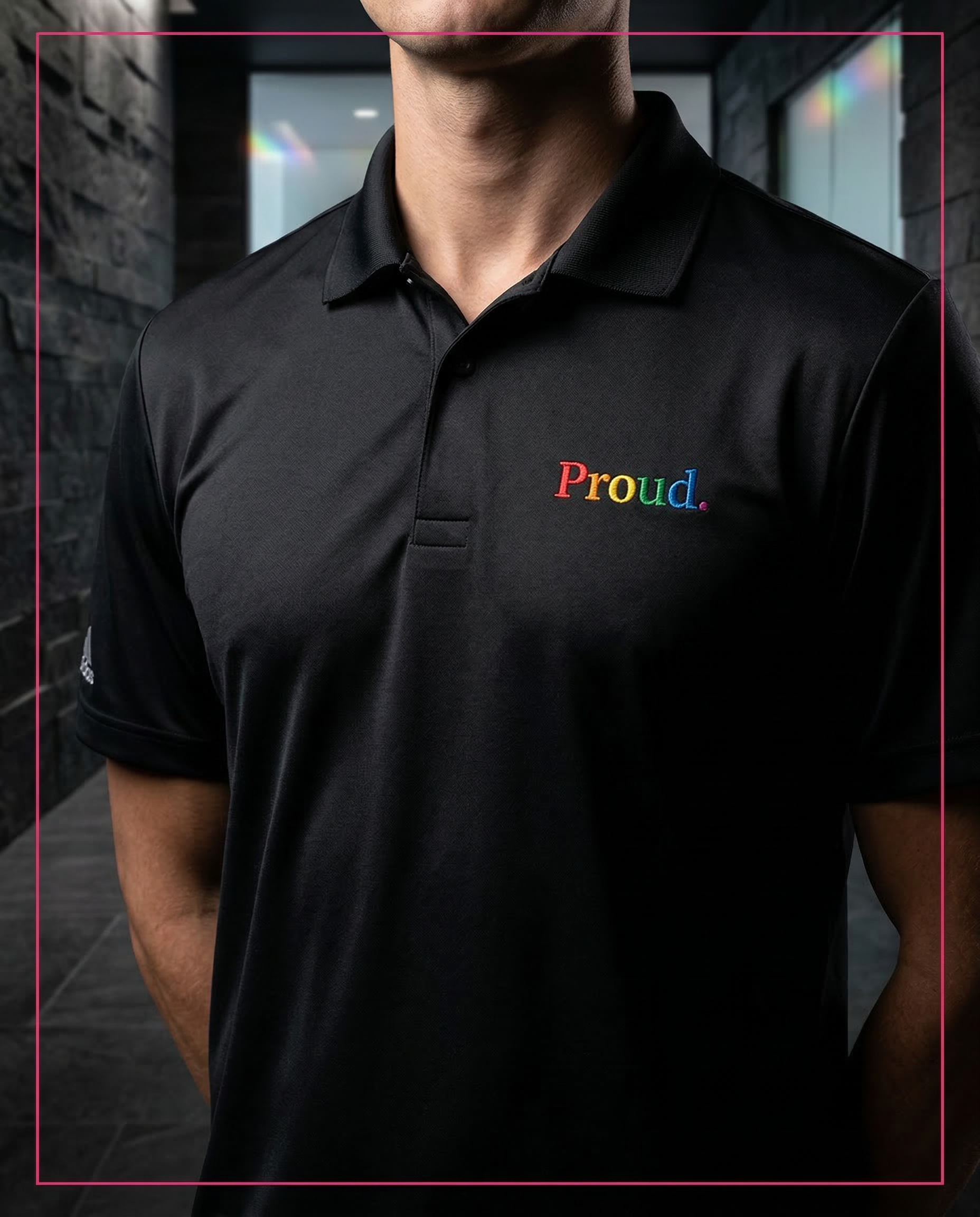 Person wearing a black polo shirt with 'Proud.' in colorful letters. Proud Adidas Performance Polo