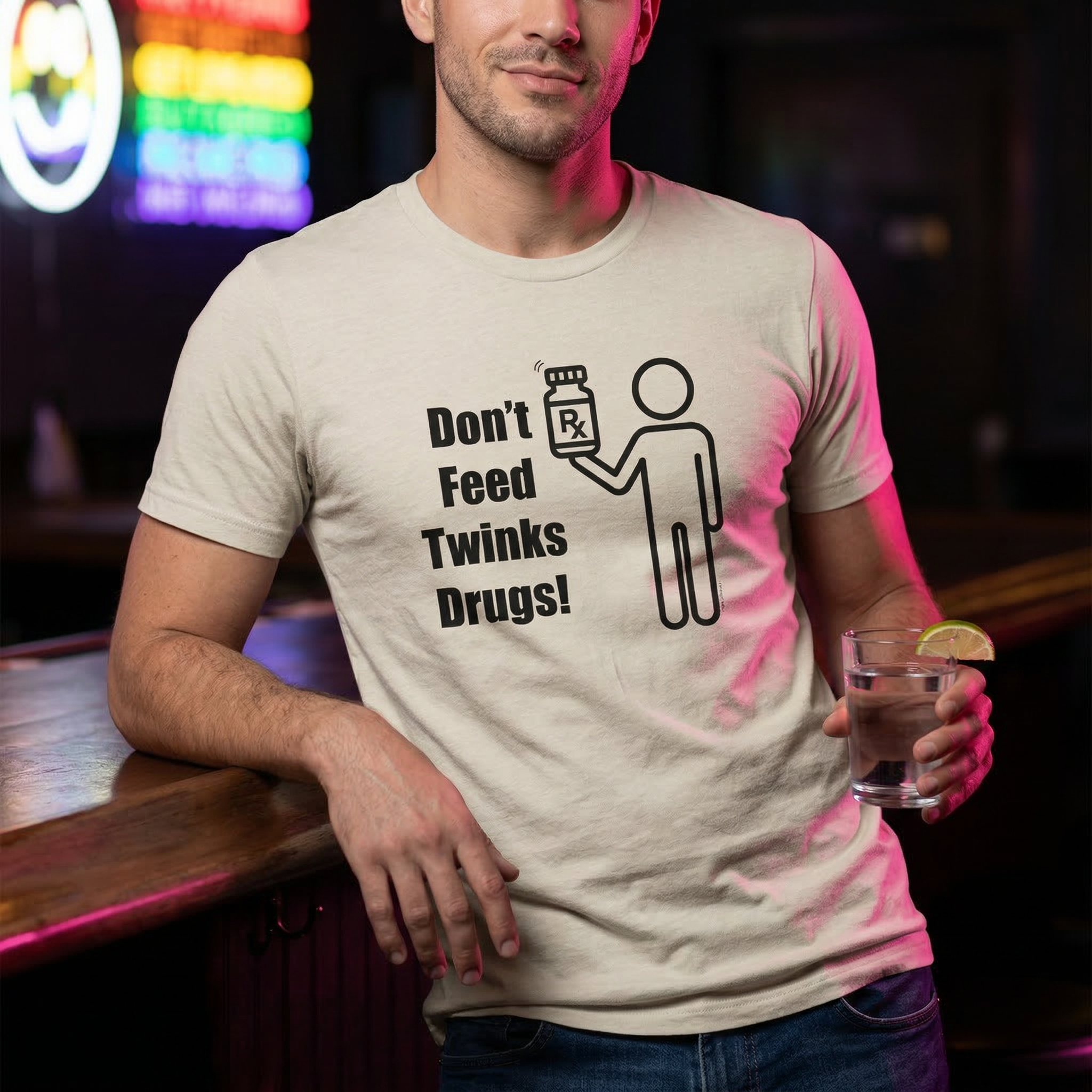 Man wearing a t-shirt with a graphic and text in a bar setting X Collection: Don't Feed Twinks Drugs Tri-Blend Graphic Tee. Funny gay shirts and pride shirts made by Pride Clothing Co. 